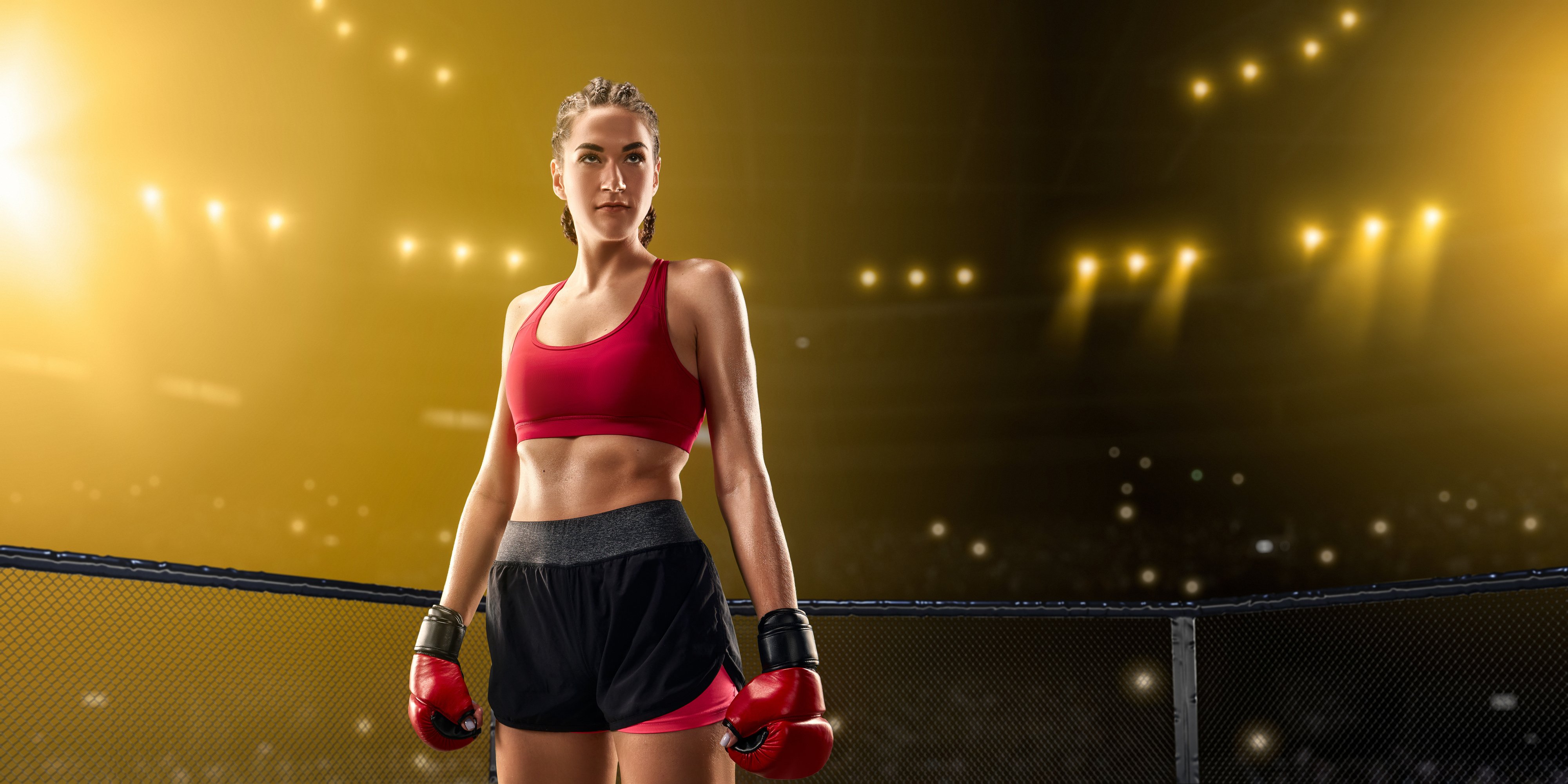 Female MMA fighter in professional boxing ring